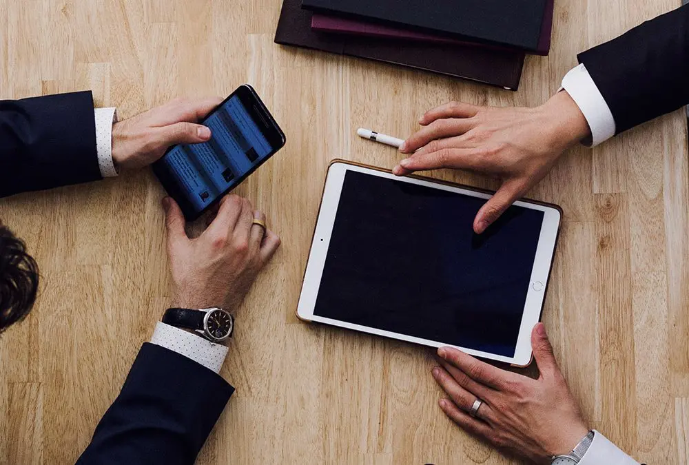 2 business men using electronics